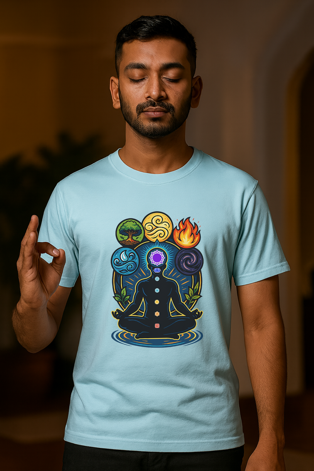 Man wearing a light blue t-shirt with a colorful design of seven chakras.
