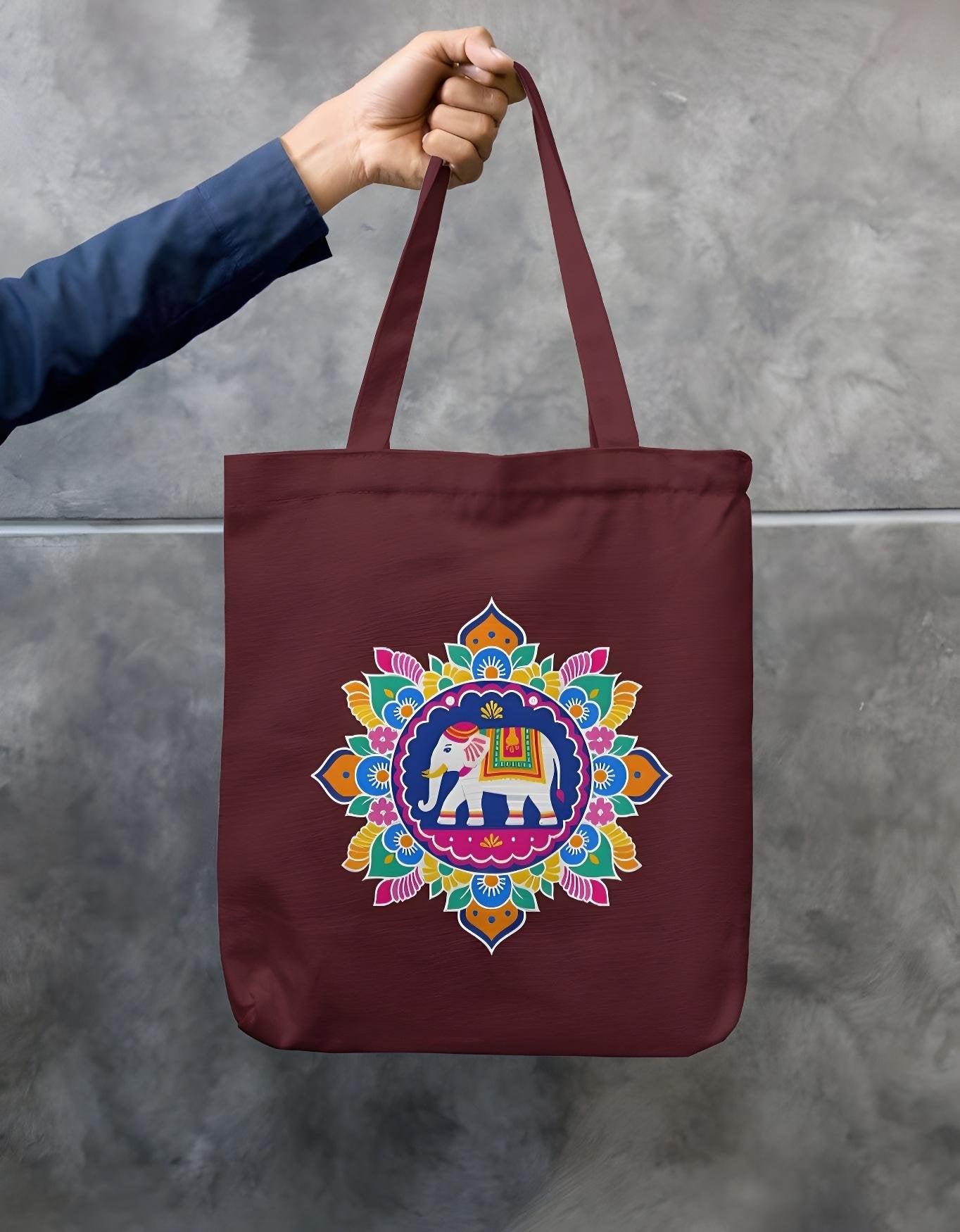 Maroon cotton canvas tote bag with detailed elephant mandala artwork, eco-friendly double sided print, and secure zipper closure.